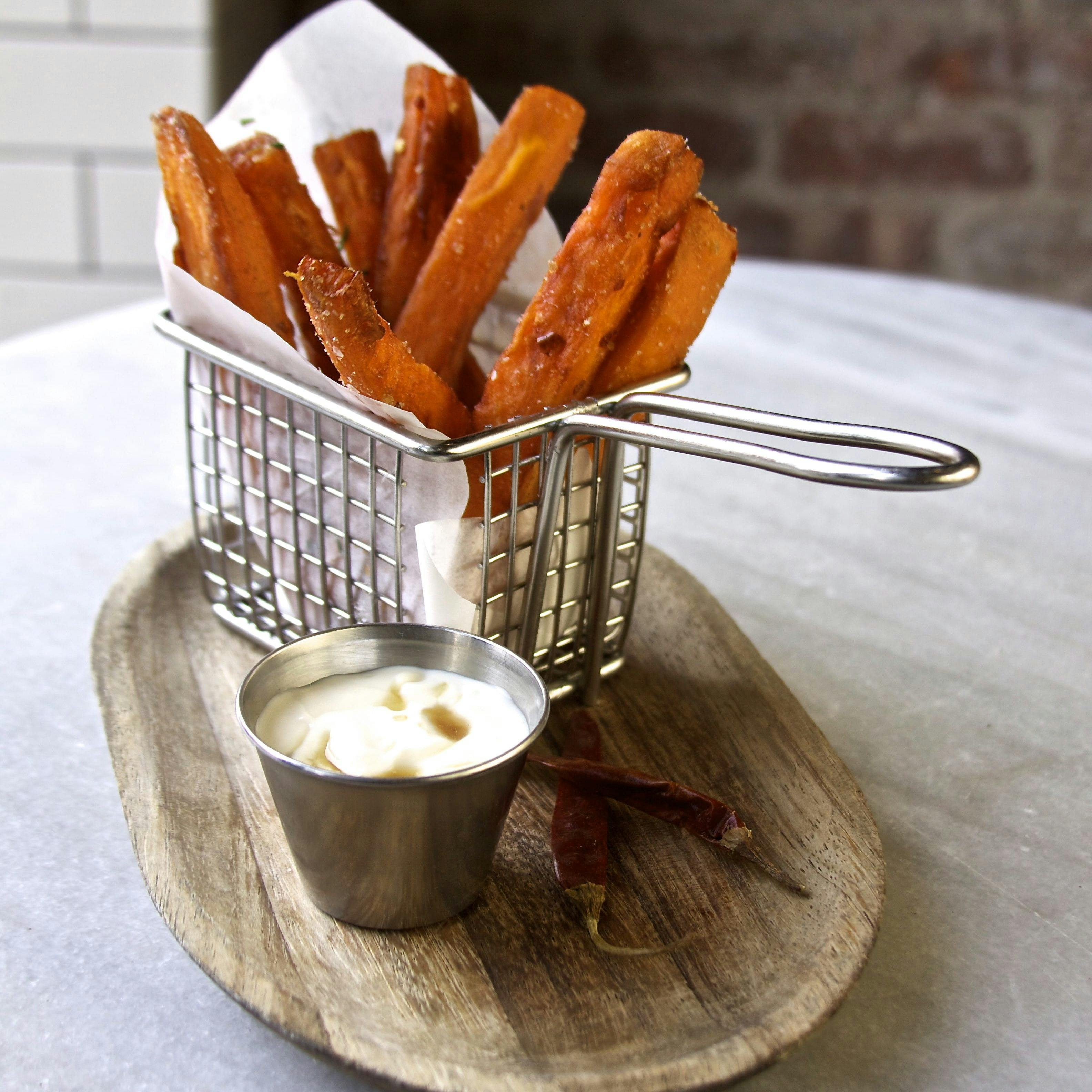 sweet potato fries in a basket with mayo