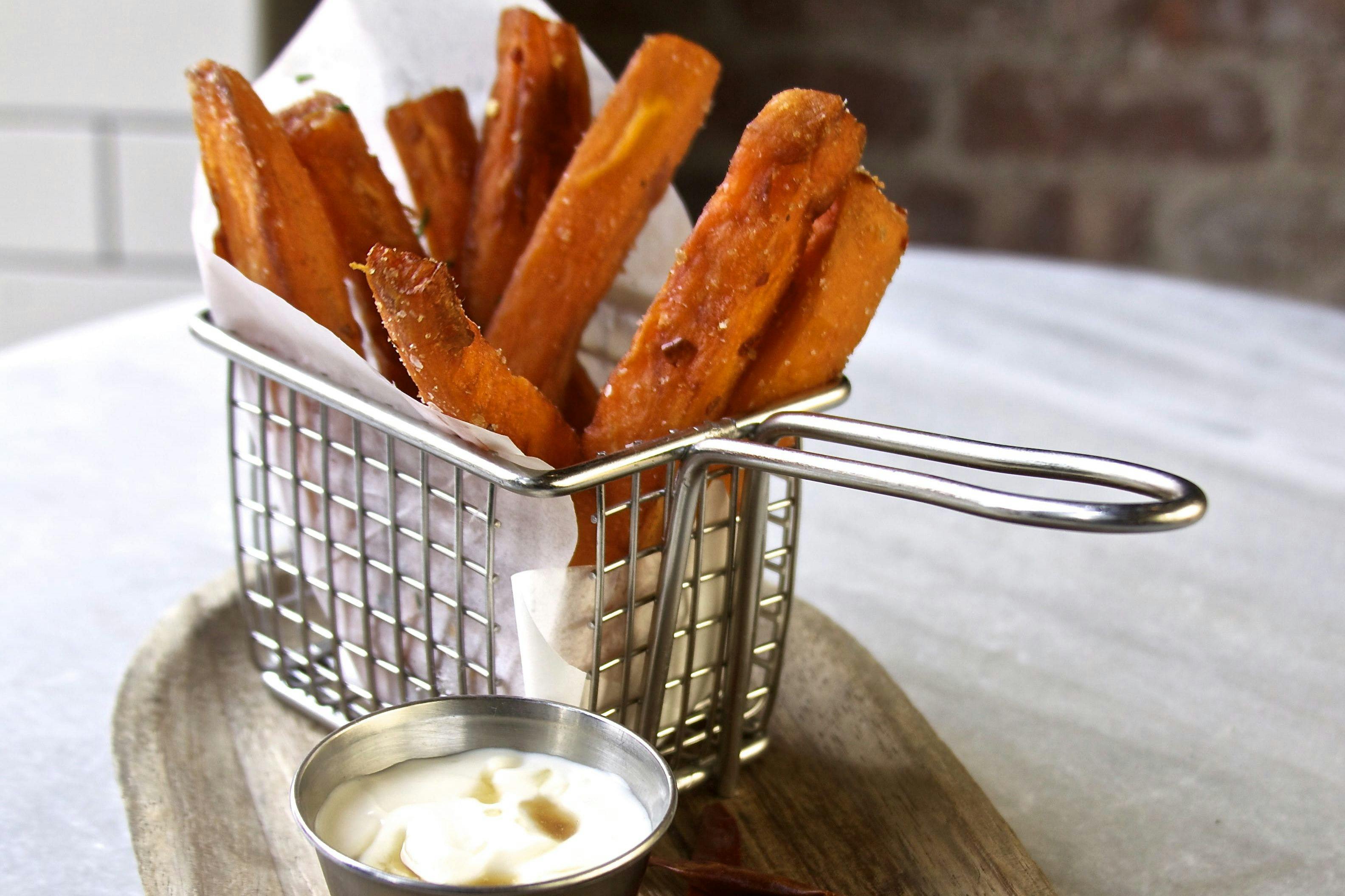 sweet potato fries in a basket with mayo