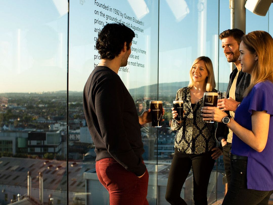 People drinking pints of Guinness at the Gravity Bar in the Guinness Storehouse